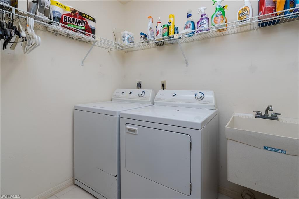 1502 Foxfire Lane Naples, FL 34104 - Photo 36 of 49 a utility room with dryer and washer