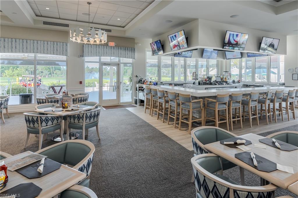 1502 Foxfire Lane Naples, FL 34104 - Photo 38 of 49 a dining room with furniture a chandelier and wooden floor