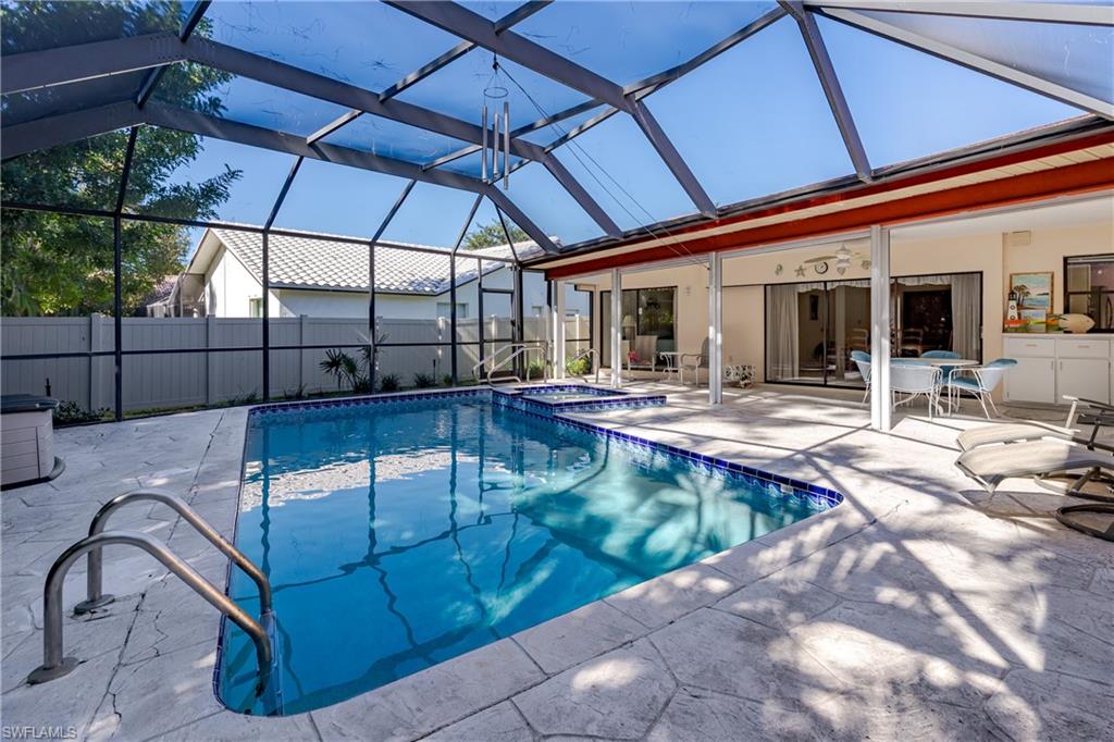 1502 Foxfire Lane Naples, FL 34104 - Photo 7 of 49 a view of a swimming pool with a patio