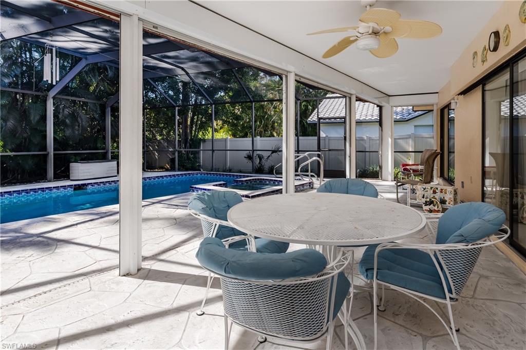 1502 Foxfire Lane Naples, FL 34104 - Photo 10 of 49 a dinning table and chairs in patio of the house