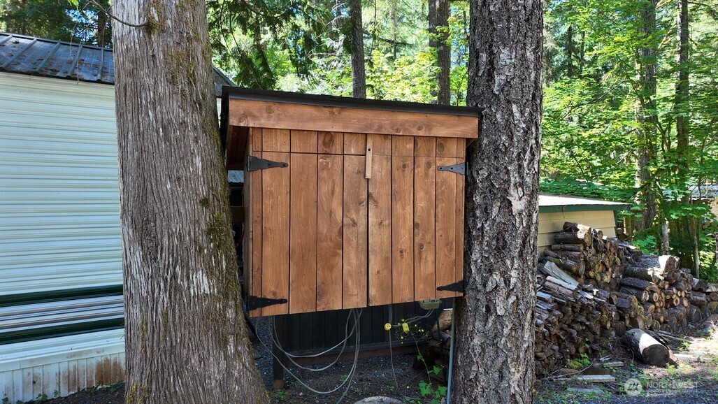 82 Riverside Drive Deming, WA 98244 - Photo 6 of 33 a wooden fence with a tree in the background