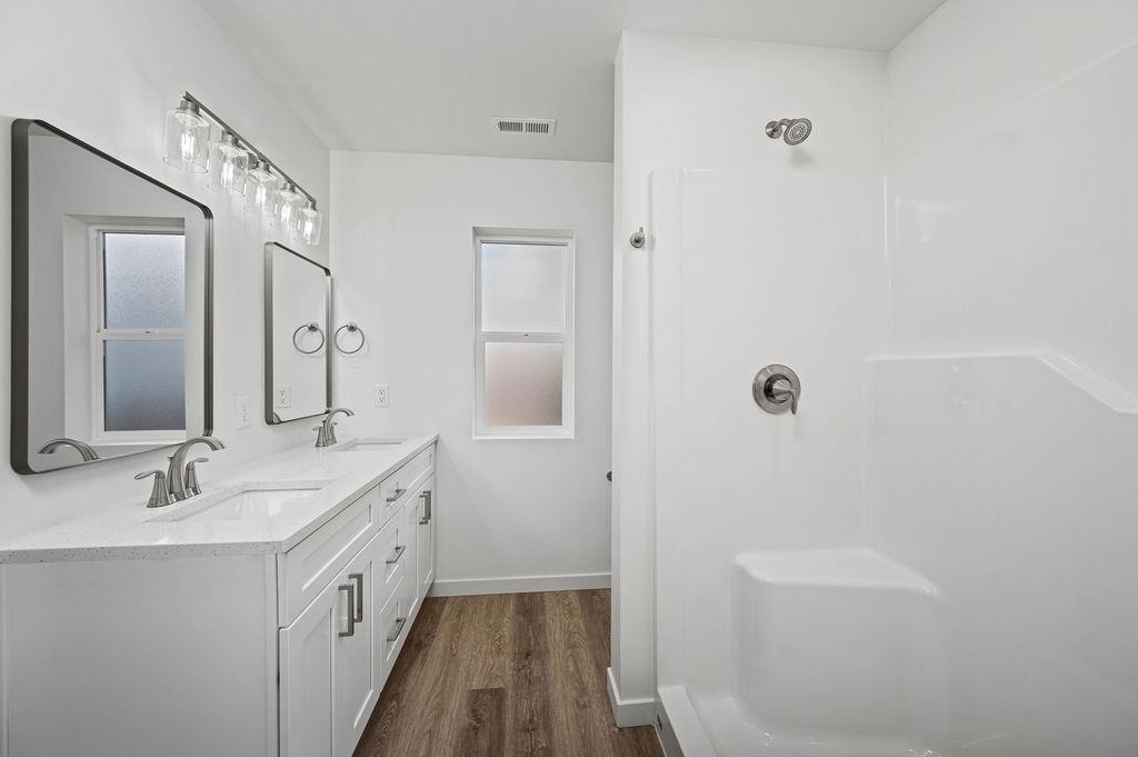 166 Orchard View Way Grand Junction, CO 81503 - Photo 13 of 20 a bathroom with a double vanity sink a mirror and a shower