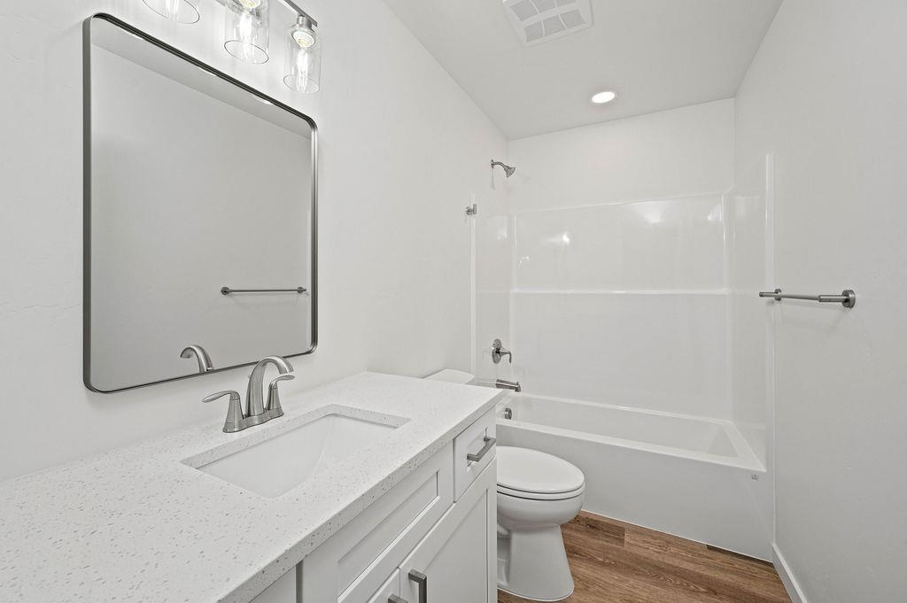 166 Orchard View Way Grand Junction, CO 81503 - Photo 17 of 20 a bathroom with a granite countertop sink a toilet and shower