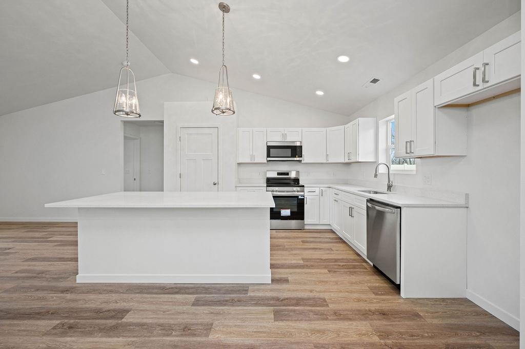 166 Orchard View Way Grand Junction, CO 81503 - Photo 7 of 20 a large kitchen with cabinets and wooden floor