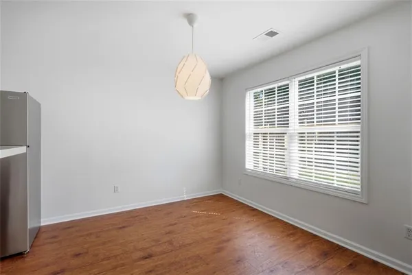 a view of a kitchen with wooden floor and a sink