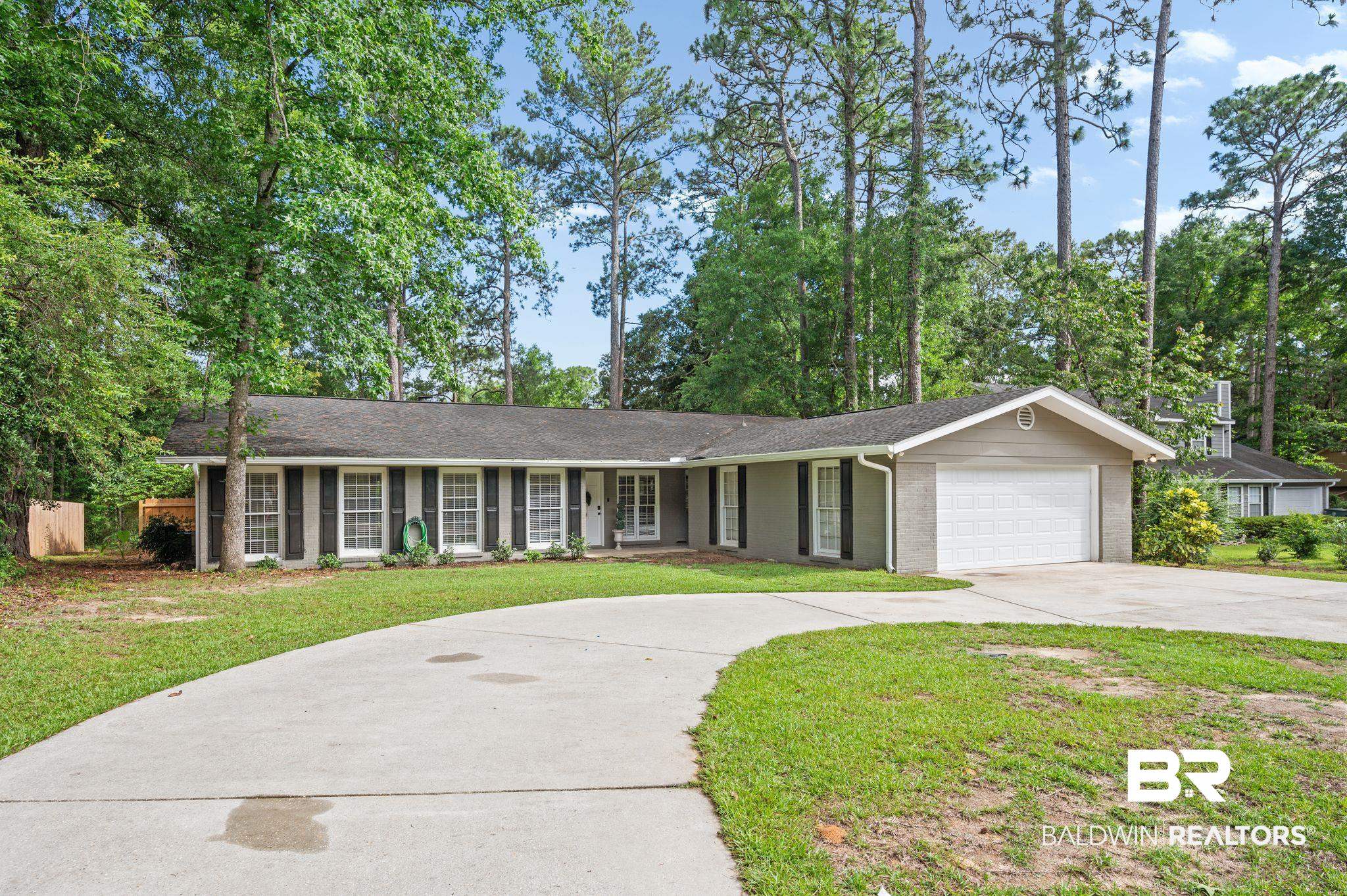 110 Ferncliff Circle Daphne, AL 36526 - Photo 2 of 40 Ranch-style house featuring driveway, a garage, a front lawn, and brick siding