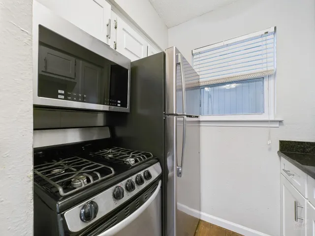 a kitchen with a stove and a refrigerator