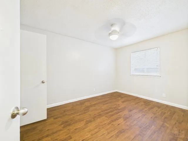 a view of a room with wooden floor