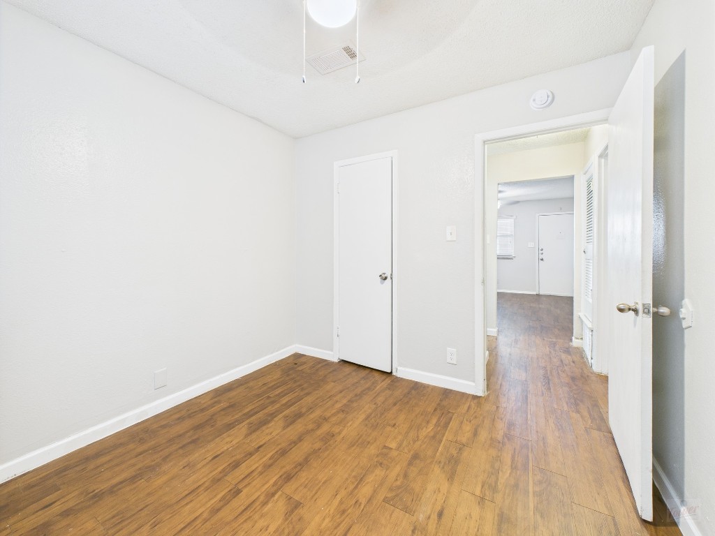 2401 Manor Road, Unit 136 Austin, TX 78722 - Photo 8 of 12 a view of a room with wooden floor