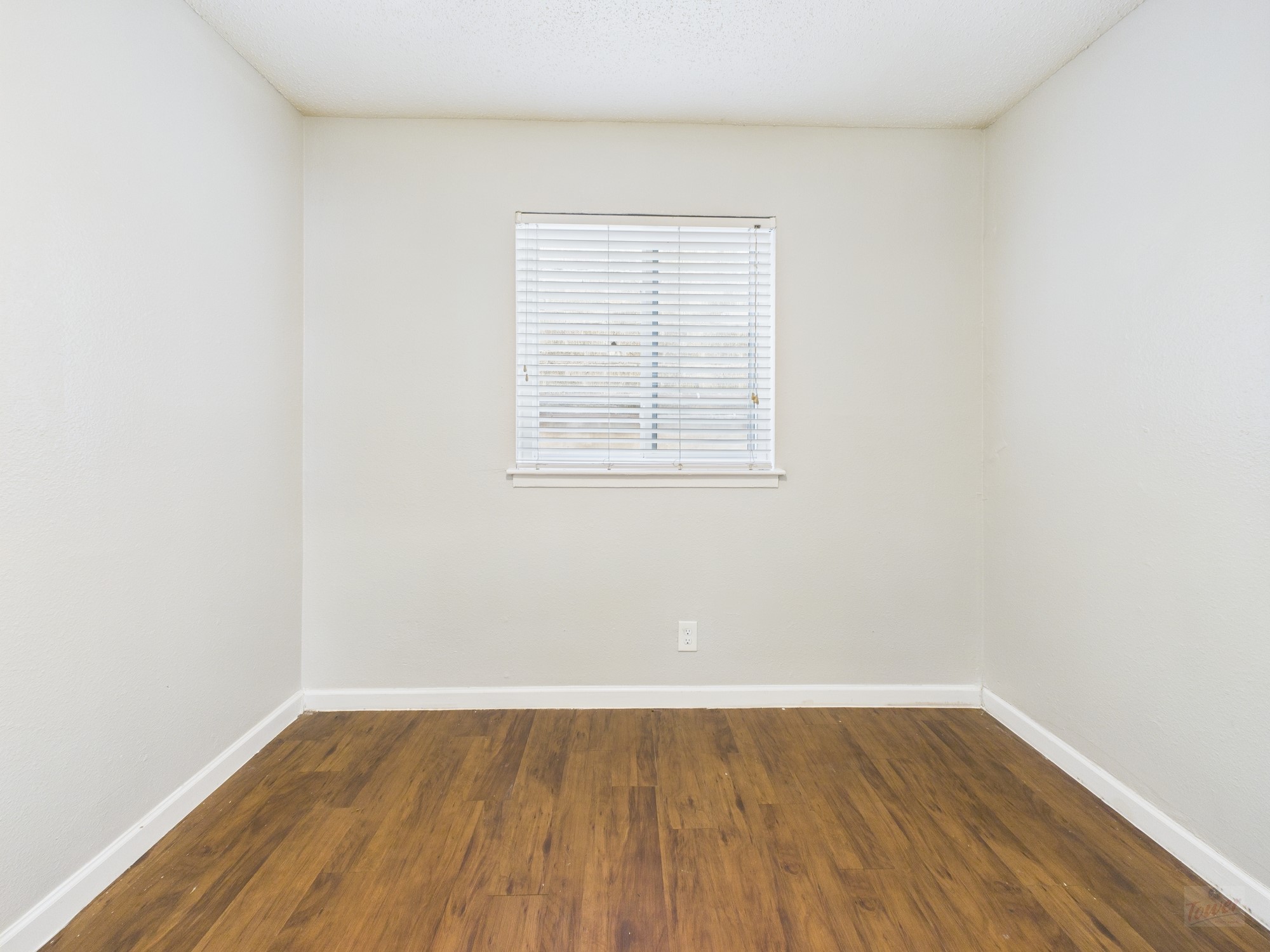 2401 Manor Road, Unit 136 Austin, TX 78722 - Photo 9 of 12 an empty room with wooden floor and window