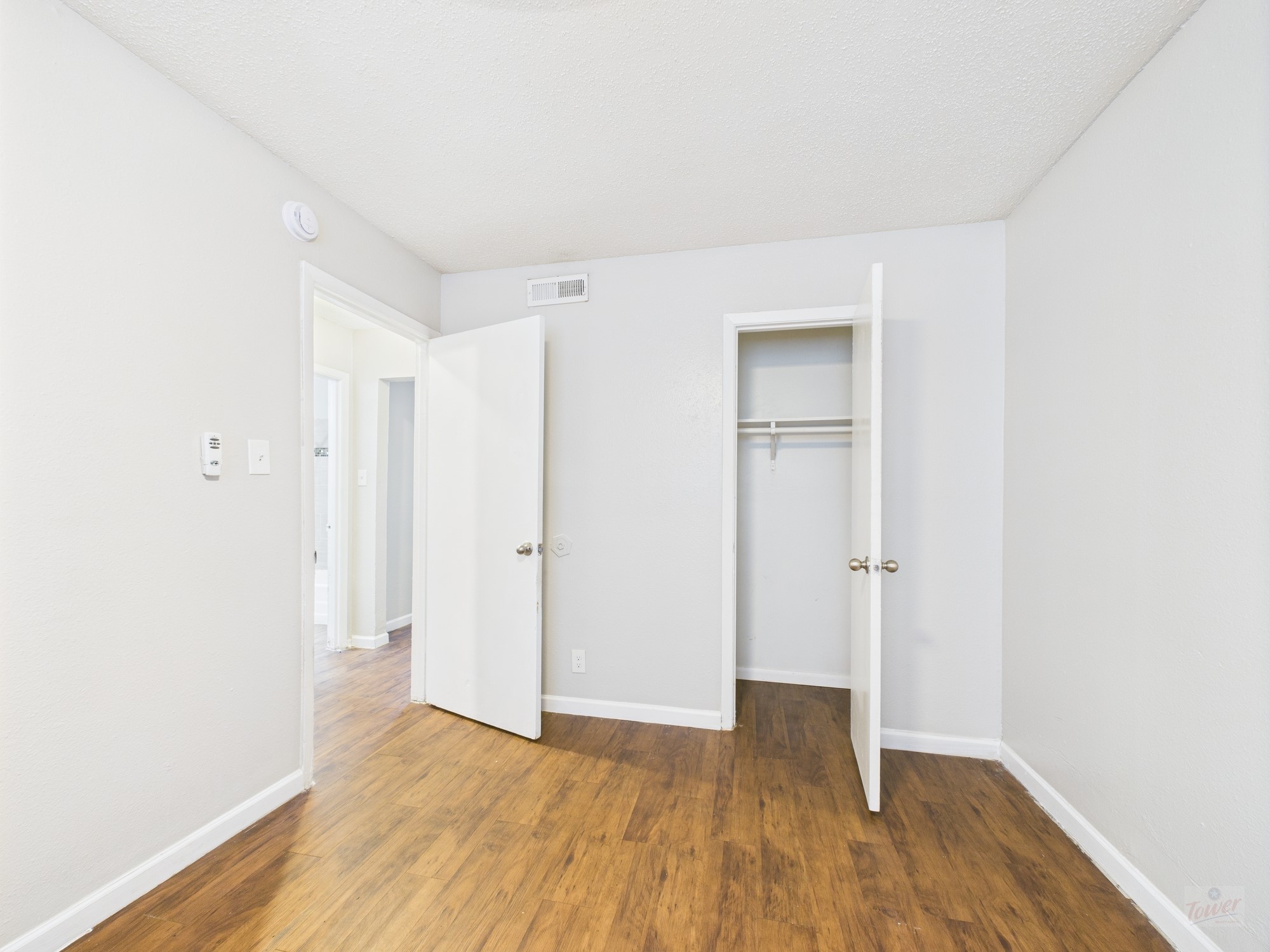 2401 Manor Road, Unit 136 Austin, TX 78722 - Photo 10 of 12 a view of an empty room with wooden floor