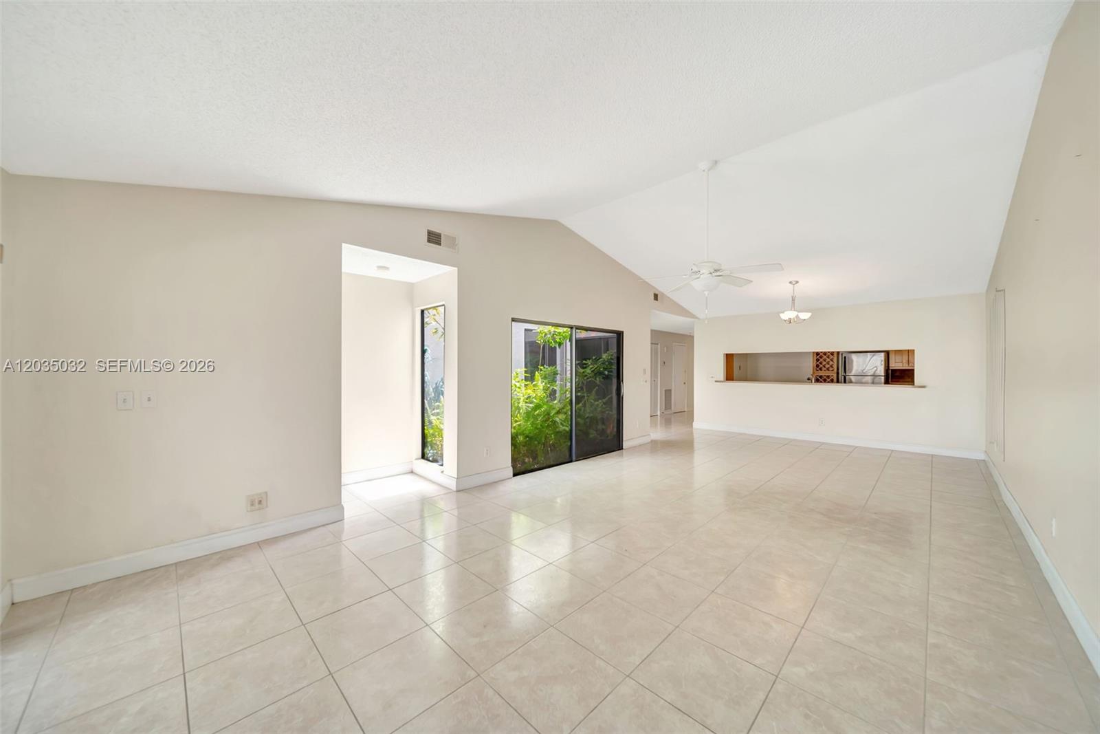 5223 Gate Lake Road, Unit 5223 Tamarac, FL 33319 - Photo 19 of 37 a view of an empty room with wooden floor and a window