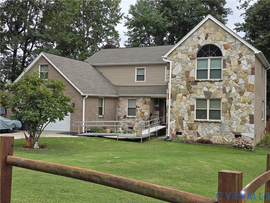 a front view of a house with a garden and trees