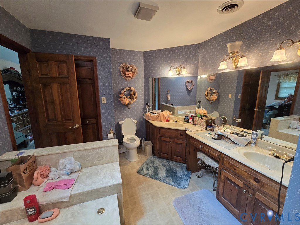 701 Whitestone Place Colonial Heights, VA 23834 - Photo 25 of 25 a spacious bathroom with a granite countertop sink and a mirror