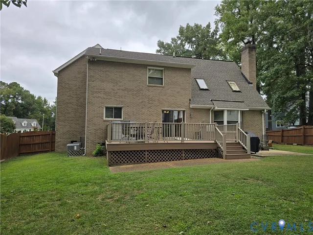 a front view of a house with garden and trees