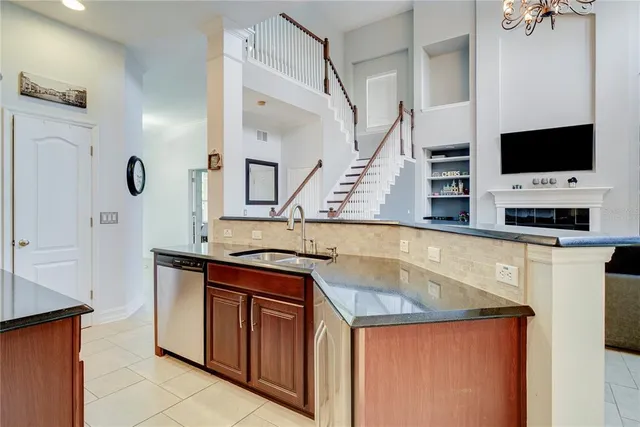 a view of a kitchen with stainless steel appliances granite countertop a sink and a stove