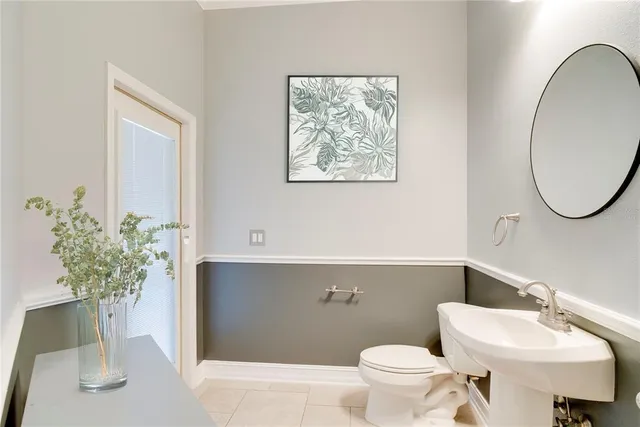 a bathroom with a toilet a sink and a mirror