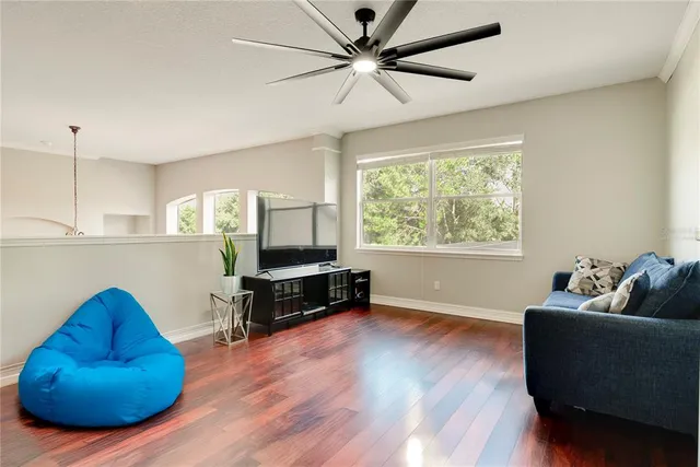 a living room with furniture and a wooden floor