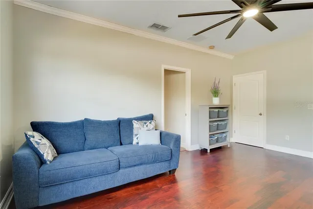 a living room with furniture and a ceiling fan