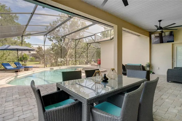 a view of an outdoor dining space with a table and chairs