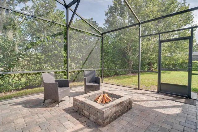 a view of a couches in the patio with a backyard