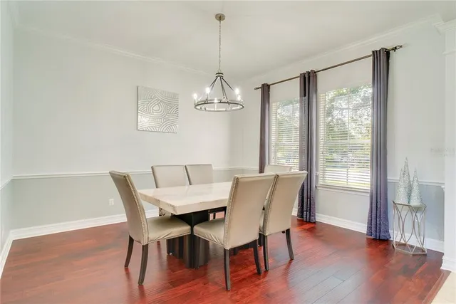 a view of a dining room with furniture wooden floor and chandelier