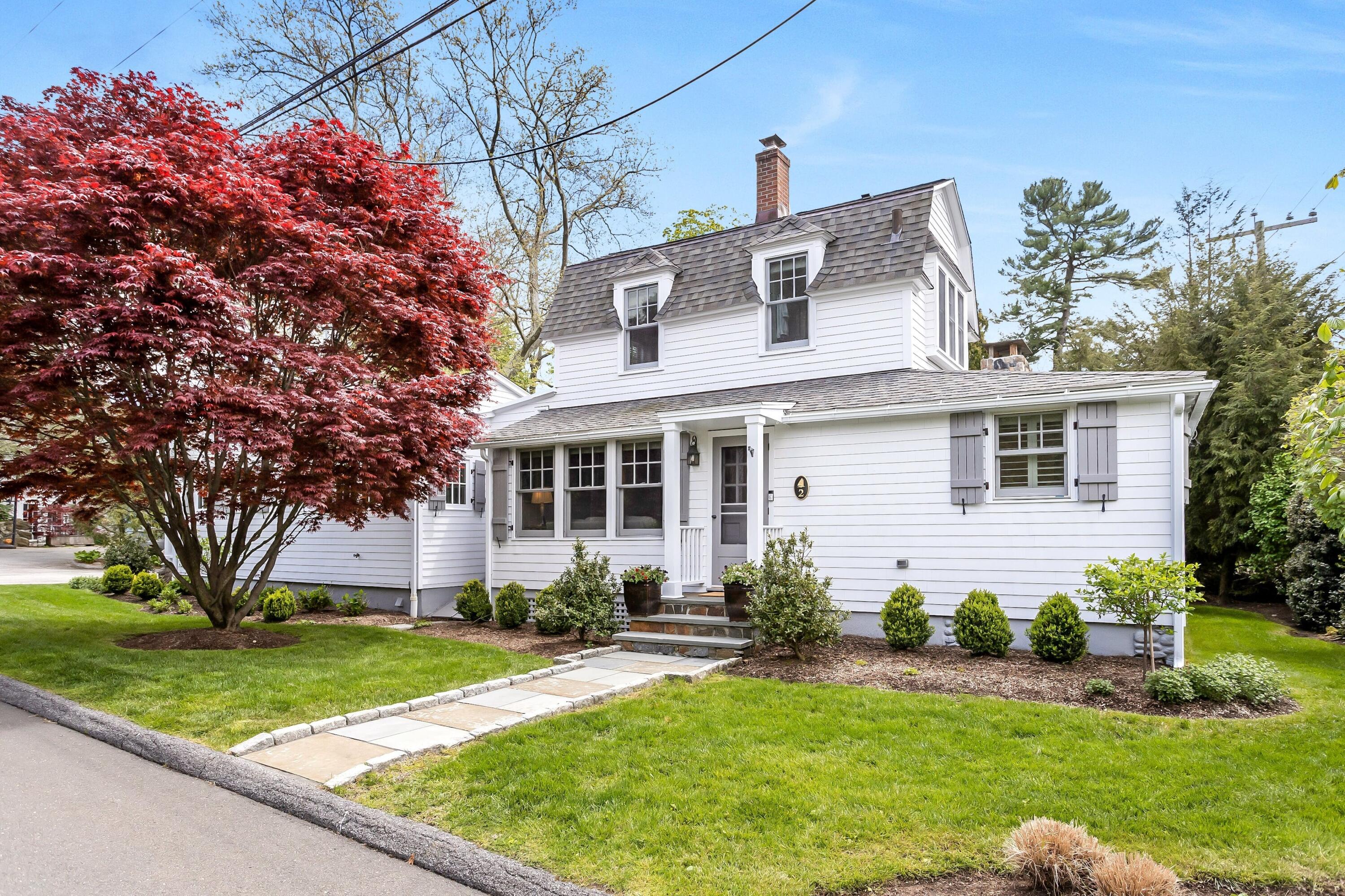 a front view of a house with a yard