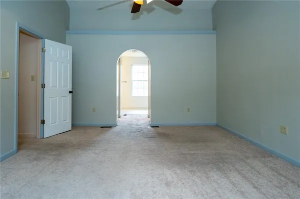 an empty room with windows and glass door