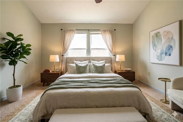 a bedroom with bed and a potted plant