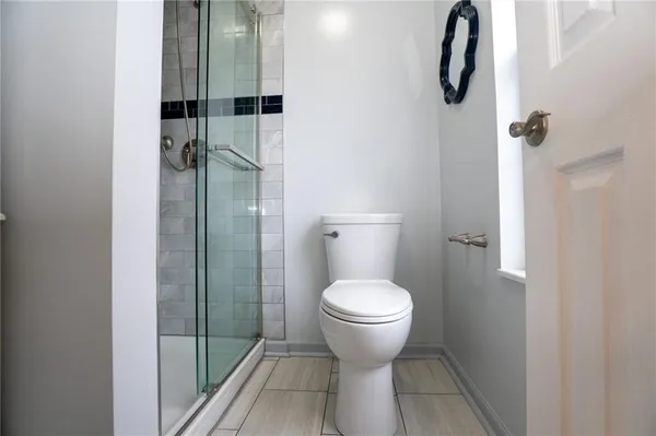 a bathroom with a toilet and a shower