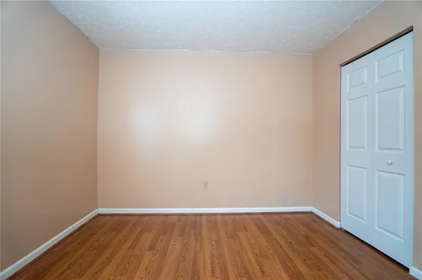 a view of an empty room and wooden floor