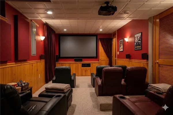 a room with furniture projector and screen