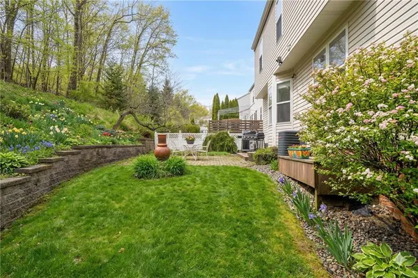 a view of backyard of house with green space