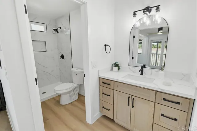 a spacious bathroom with a sink a toilet and a mirror