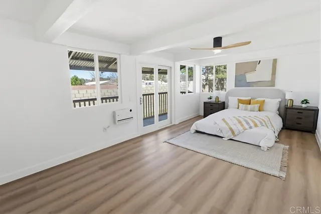 a bedroom with a large bed and a window