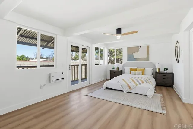 a spacious bedroom with a bed and window