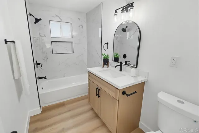 a bathroom with a sink a toilet and a mirror