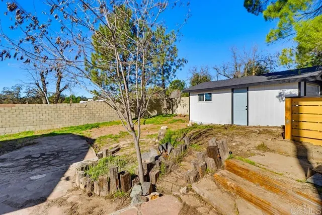 a view of a yard with a tree