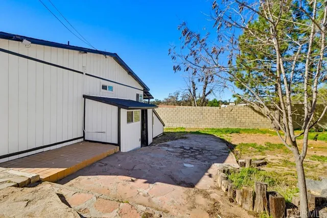 a view of a backyard with a large tree