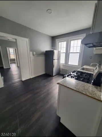 a living room with hard wood floors and a fireplace