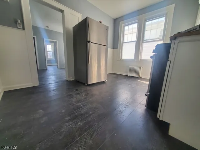 a view of a refrigerator in kitchen and wooden floor