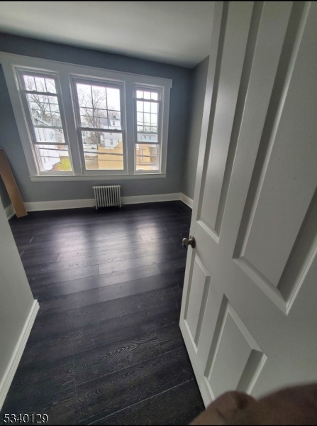 127 Sunset Avenue, Unit 1 Newark, NJ 07106 - Photo 8 of 12 a view of an empty room with wooden floor and a window