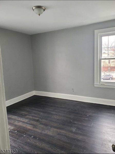 127 Sunset Avenue, Unit 1 Newark, NJ 07106 - Photo 10 of 12 a view of an empty room with wooden floor and a window