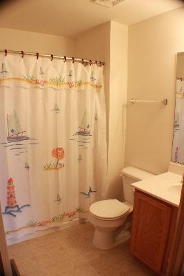 255 South Oak Creek Lane Romeoville, IL 60446 - Photo 5 of 7 a bathroom with a toilet a sink and curtain