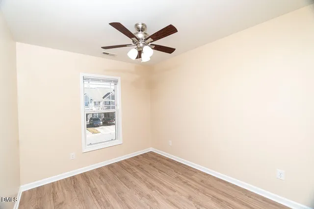 a view of a big room with wooden floor closet and windows