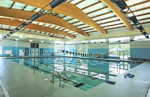 a view of a swimming pool with outdoor seating