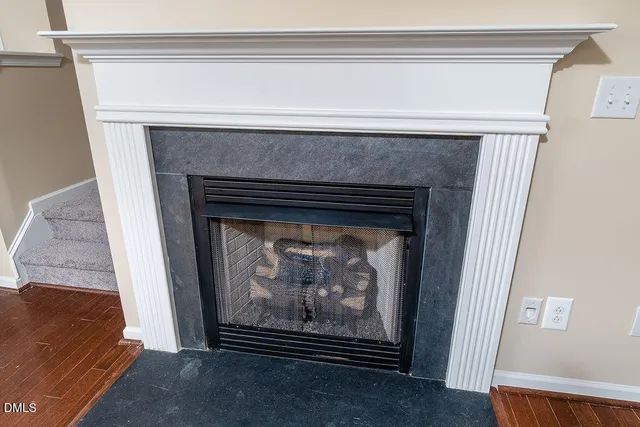 a view of fireplace with wooden floor