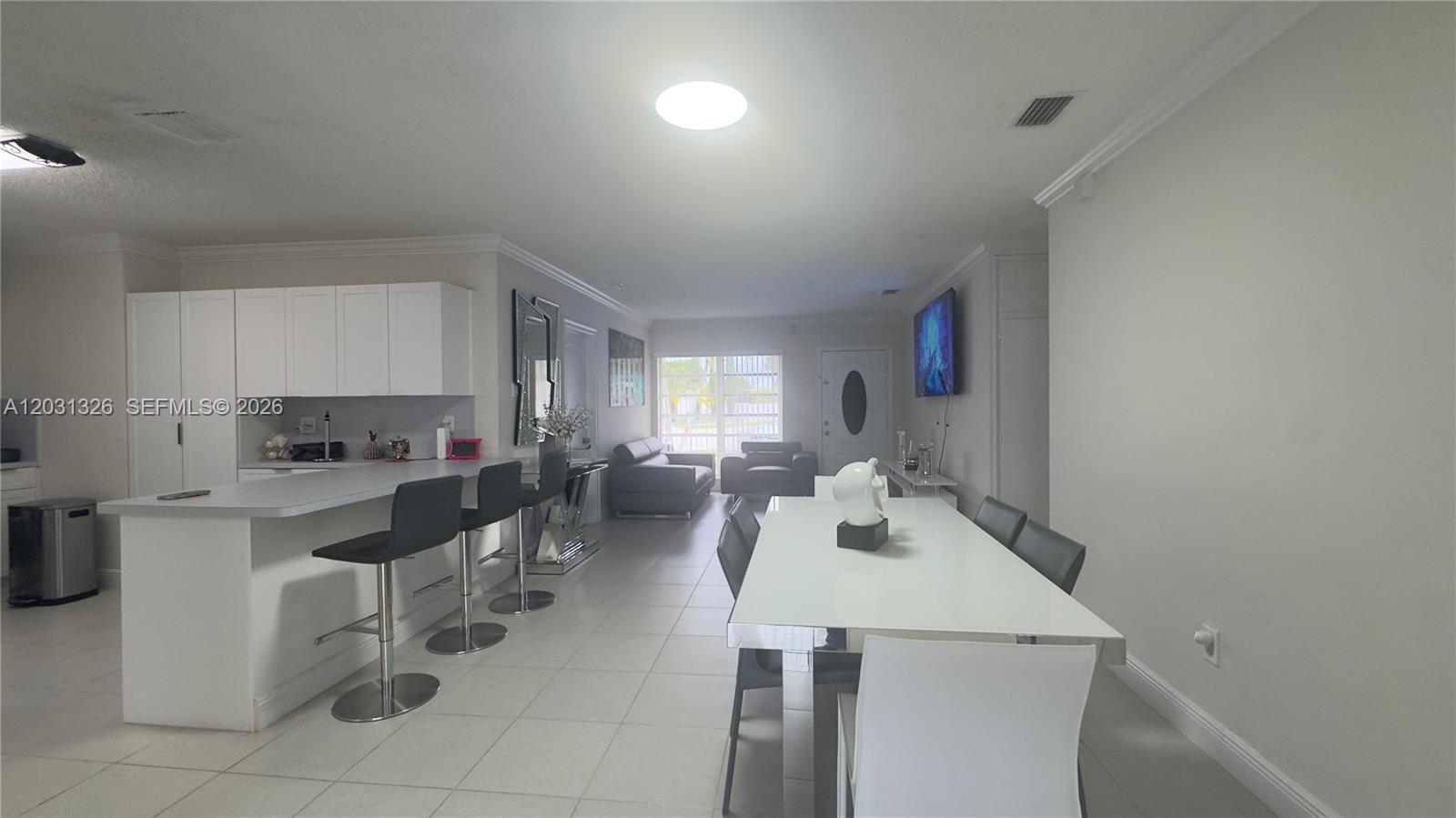 12480 Southwest 189th Street Miami, FL 33177 - Photo 4 of 25 a kitchen with a sink a stove and chairs