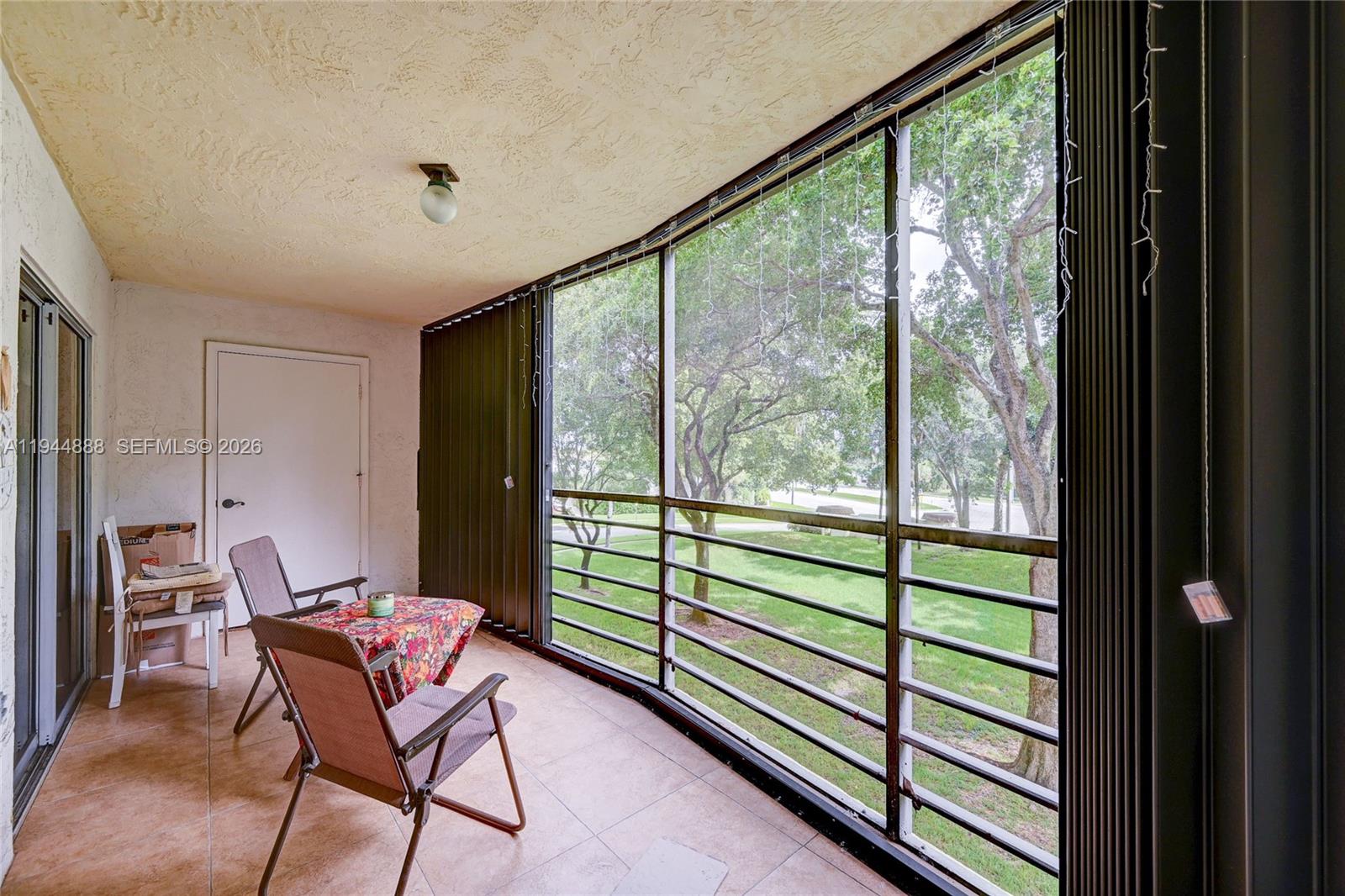 23344 Carolwood Lane, Unit 303 Boca Raton, FL 33428 - Photo 18 of 26 a view of a room with a large window and furniture