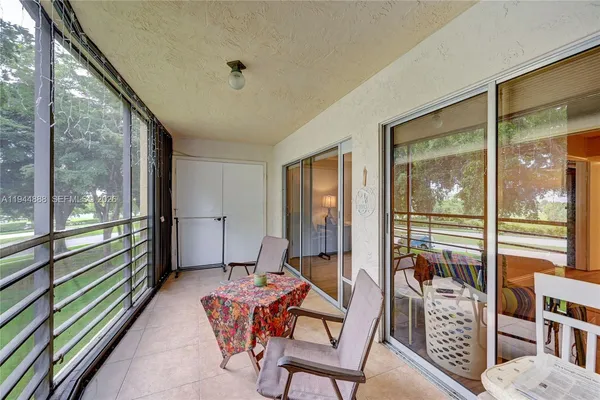 a room with furniture and large windows